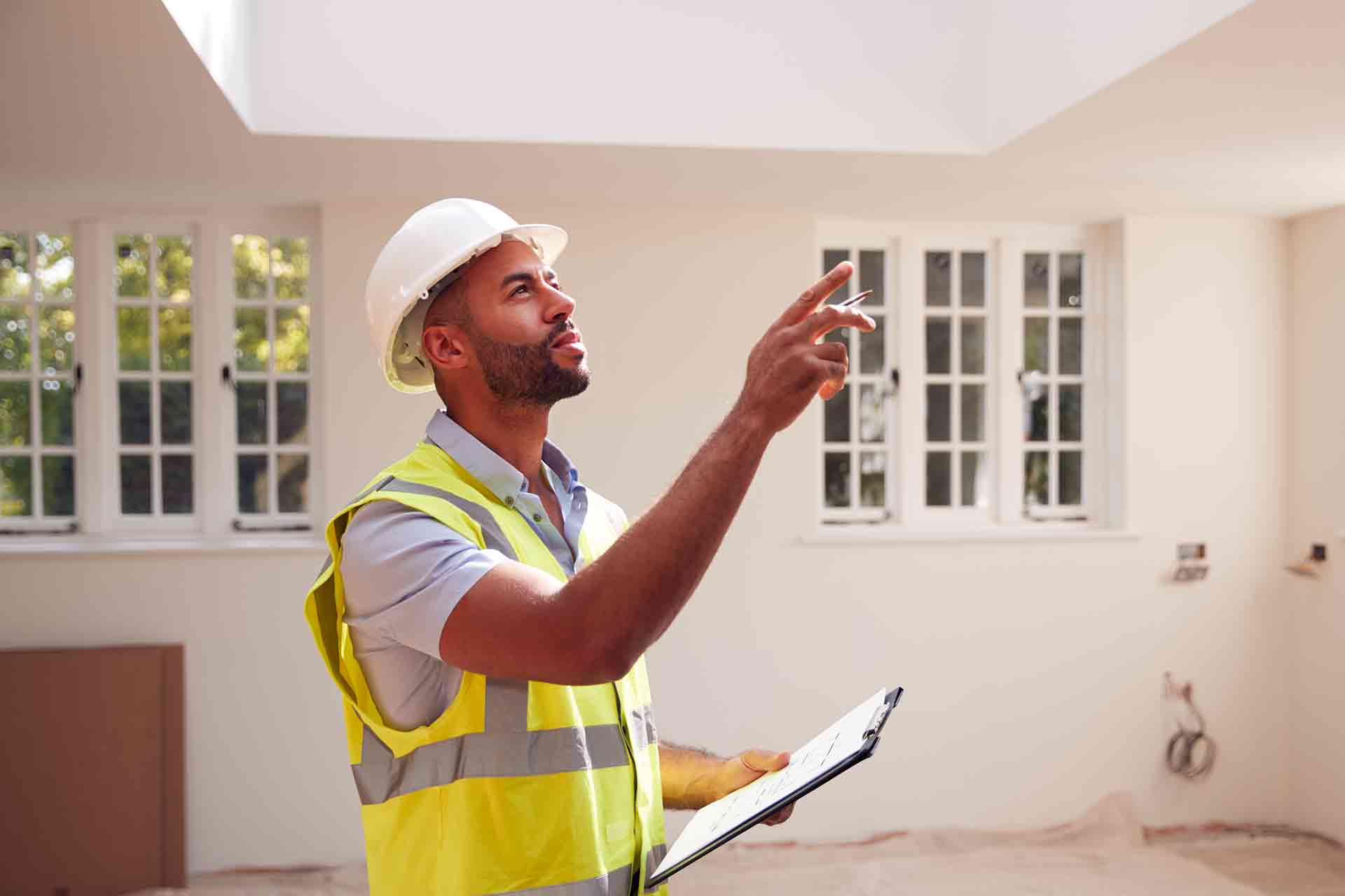 Third Party Wall Surveyors Ipswich reviewing plans between two parties during a dispute